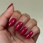 Hand with natural nails painted in glossy Roar gel polish showing a smooth, quick dry mani on neutral background