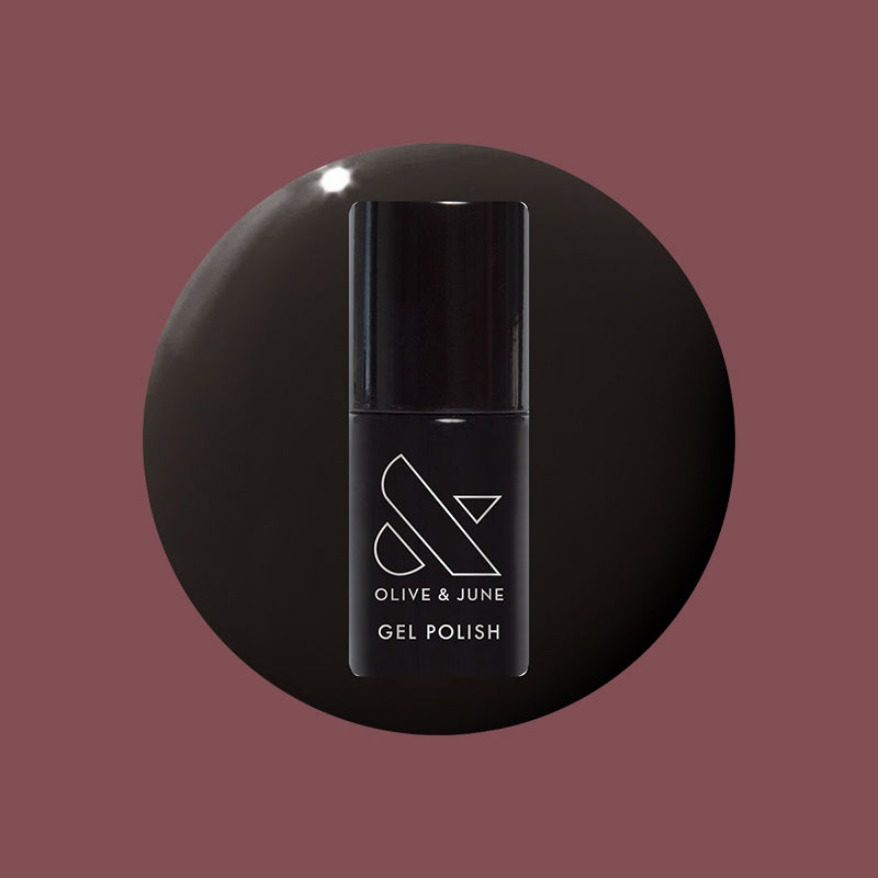 Shop Til You Drop Gel bottle on a dark vampy red background for a bold, dramatic long-lasting mani by Olive and June