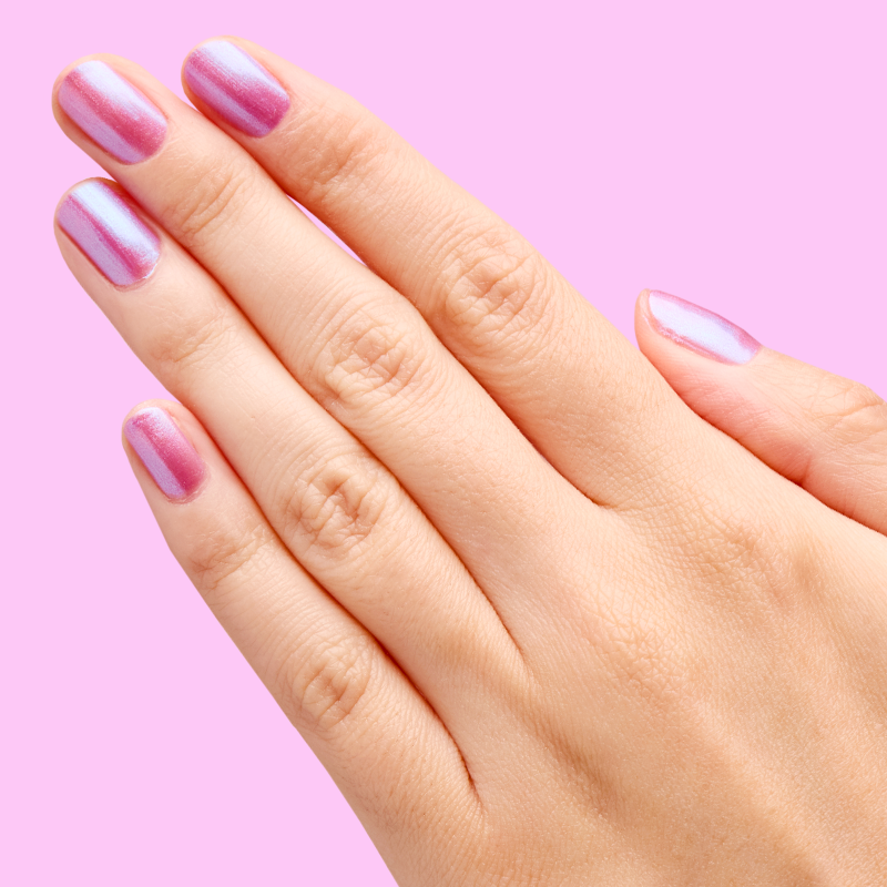 Hand with nails painted in jelly purple-blue iridescent duochrome using SWAK quick dry polish by Olive and June