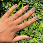 Hand with medium skin tone wearing smooth Sable gel polish manicure with natural nails outdoors in sunlight