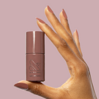 Shacket - Gel polish bottle held with warm rose neutral gel manicured nails by Olive and June