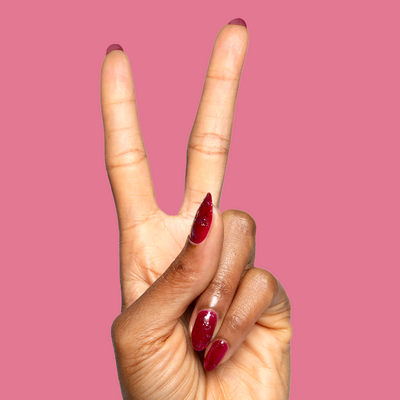 Shopportunity! nail polish shown on nails with deep cabernet jelly shade and holographic flakes for mani looks Shopportunity! cranberry jelly with holographic flakes Nail Polish