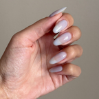 Sky Blue Filter - Builder Gel on almond-shaped nails with a translucent pastel blue manicure and glossy finish in natural light
