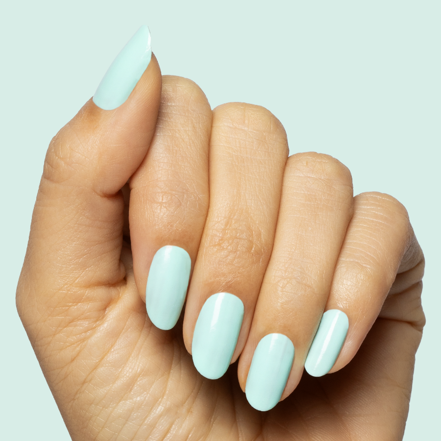 Hand with long nails painted in soft turquoise using Slam Dunk gel polish for a smooth at-home manicure