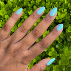 Hand with smooth nails painted in bright true turquoise using Slam Dunk gel polish for an at-home manicure