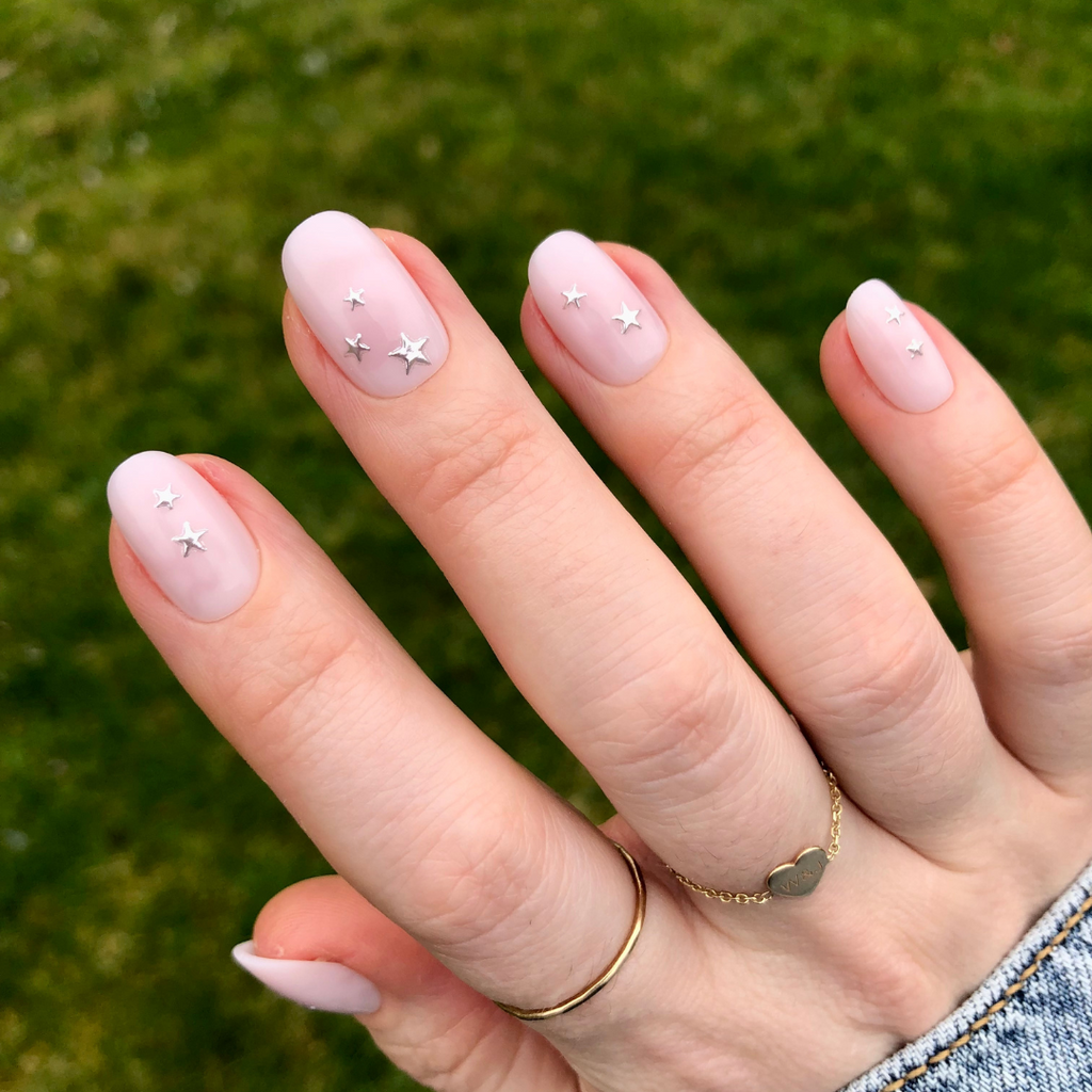 Soft Silver Foil Stars - Press-On | Short | Round showing short round nails with neutral polish and 3D silver stars design