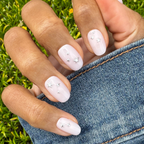 Soft Silver Foil Stars - Press-On | Short | Round showing hand with short round nails and 3D silver star accents outdoors