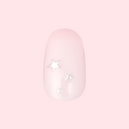 Soft Silver Foil Stars - Press-On | Short | Round showing short round false nail with pale pink base and 3D silver star accents