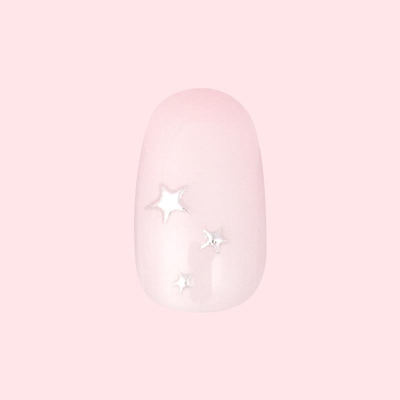 Soft Silver Foil Stars - Press-On | Short | Round showing short round false nail with pale pink base and 3D silver star accents