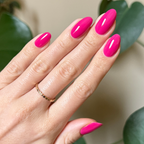 Hand with nails painted in glossy bright magenta using Wild Orchid - Gel for a bold, long-lasting manicure look at home
