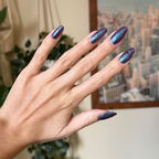 You Obviously Need It iridescent purple-blue glitter gel polish on long almond-shaped nails for a vibrant manicure