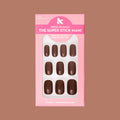 Americano | Short | Squoval - Tab Press-On showing a set of glossy coffee brown false nails in pink packaging on neutral background