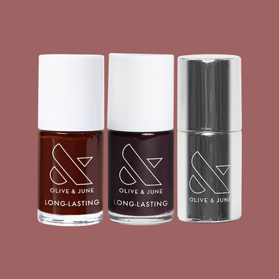 Three Olive and June nail polish bottles in rich brown, deep purple, and silver finish on muted mauve background Cherry Mocha Set  Nail Polish