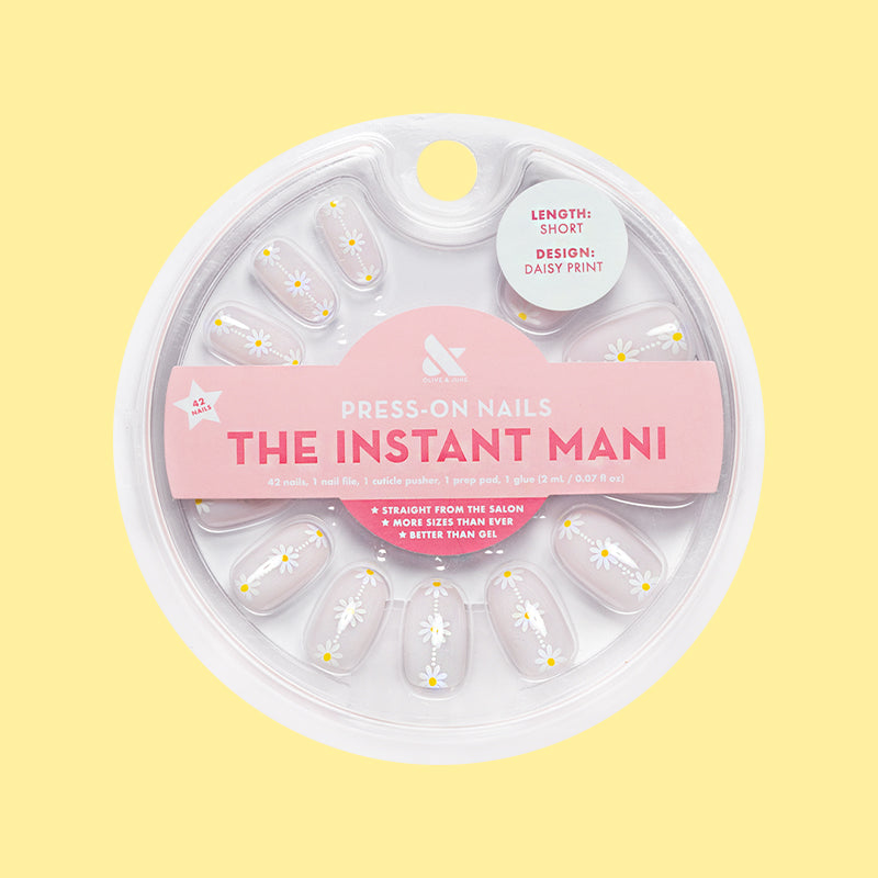 Daisy Chain - Press-On | Short | Round with delicate white daisy print on sheer neutral false nails in circular packaging