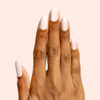 Hand with long natural nails painted in Kitten neutral greige polish showing a smooth, polished manicure look