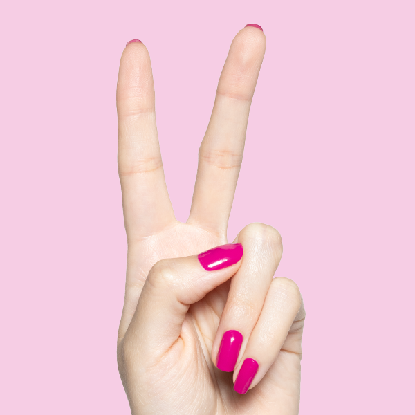 Hand showing peace sign with glossy Leotard hot magenta gel polish manicure on medium-length nails against pink background