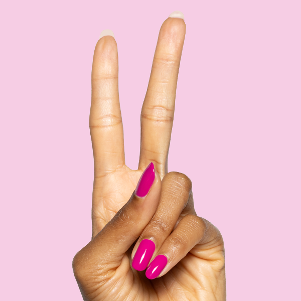 Hand showing two fingers with glossy Leotard hot magenta gel polish manicure on medium-length nails against pink background