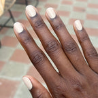 Hand with nails coated in Line Dancing Boots polish showing smooth, neutral toasted cream mani perfect for at home use