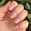 Valentine Mini Polish Set nails with clear polish and scattered soft pink heart sequins for a simple mani look thumbnail