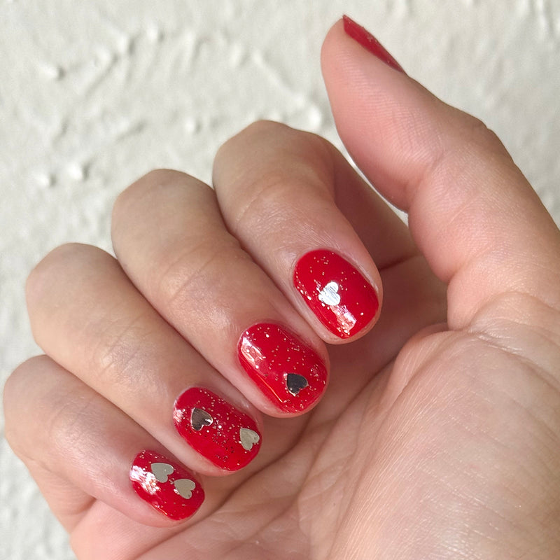 Valentine Mini Polish Set nails with shiny red polish and silver heart-shaped sequins for a festive mani look