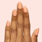 Hand with Peeptoe sheer warm peach glossy gel polish manicure on natural medium-length nails against pale pink background