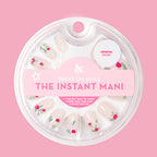 Rose Bouquets - Press-On | Short | Squoval showing squoval press-on nails with red rose bouquet designs in clear packaging on pink background