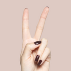 Hand showing peace sign with glossy Spressotini quick-dry gel polish manicure in deep coffee brown on short nails against beige background