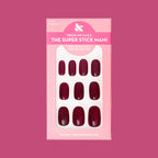 Vineyard | Short | Round - Tab Press-On displaying deep wine red short press-on nails in pink packaging on solid background