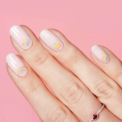 Hand with pastel nail polish and Rainbow Babe mani featuring hearts, stars, and rainbow nail art stickers on pink background Rainbow Babe  Nail Art Stickers