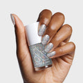Hand displaying nails painted with Exclamation Point silver holographic glitter polish for a sparkly at-home mani