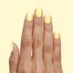 Hand with nails painted in Bright & Focused yellow for a bright, creative at-home manicure look using gel polish