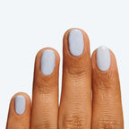 Fingers with nails painted in BP, an icy light blue gel polish ideal for a fresh and long-lasting manicure at home