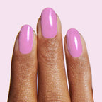 Fingers with nails painted in Fierce & Loving lilac gel polish for a smooth, long-lasting manicure by Olive and June