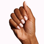 Hand with nails painted in GH, a versatile opaque baby pink polish perfect for a glowing at-home manicure