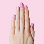 Hand with nails painted in JM pinky lavender gel polish for a fresh and feminine manicure by Olive and June