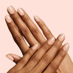 Hands with nails polished in Olive and June JO showing a smooth dusty apricot shade for a stylish mani look