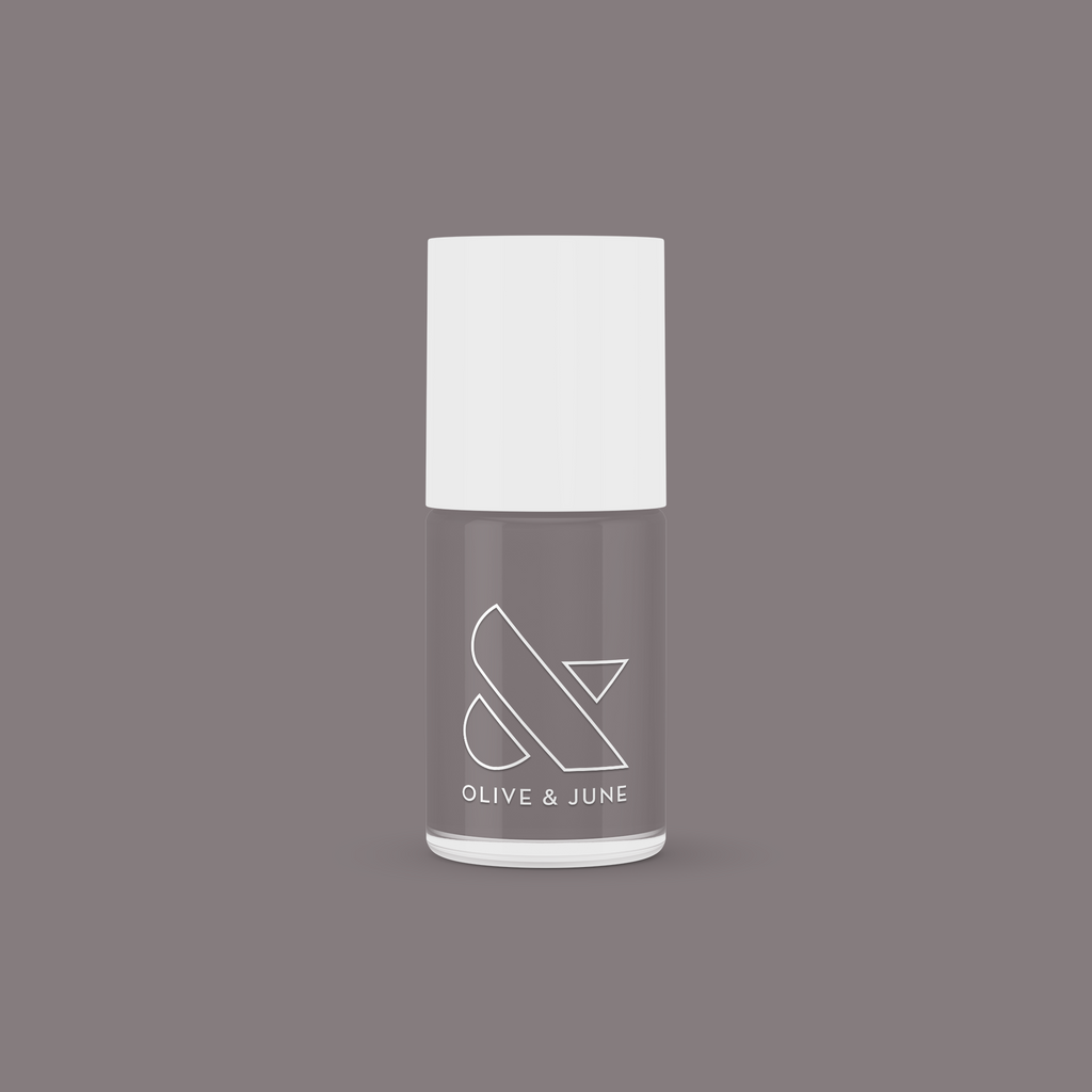 Olive and June AW nail polish bottle in warm grey shade on matching background for mani and manicure use