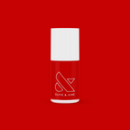 Olive and June CV nail polish bottle in bright cherry red with white cap on a vibrant red background