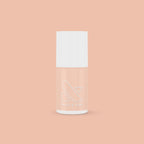 KAG nail polish bottle in neutral peachy pink shade on matching peach background for a fresh mani or pedi