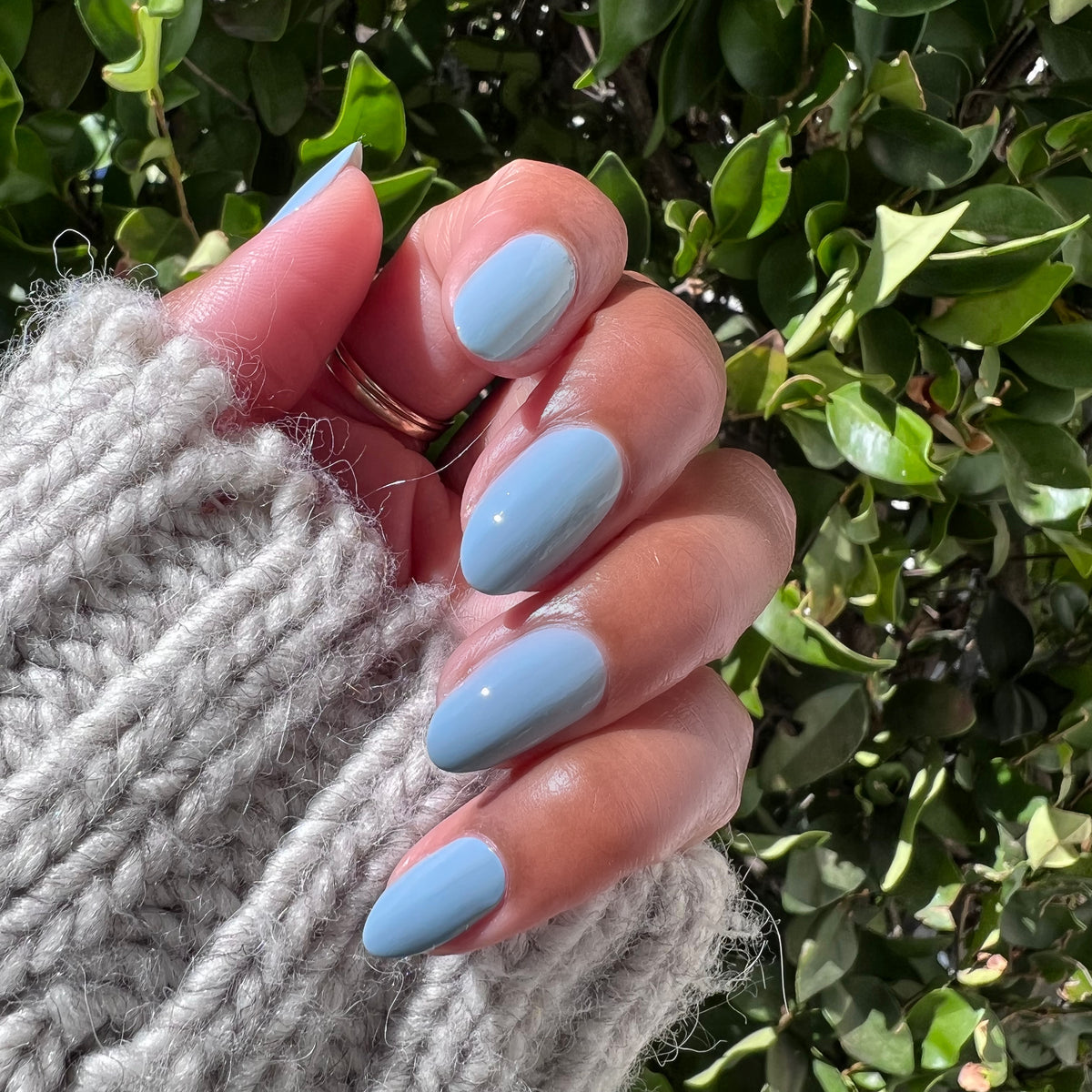Hand with nails painted in Vintage blue polish showing a glossy, quick dry manicure perfect for at-home nail care