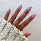 Hand with nails painted in soft purple Prairie polish featuring a smooth quick-dry manicure by Olive and June