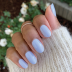 Hand with nails painted in BP, a pastel icy light blue gel polish for a smooth and lasting at-home manicure