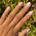Hand with natural nails painted in shiny Purple Puka gel polish showing a soft lavender iridescent manicure