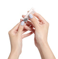 Hands holding a pale pink nail clipper from the Clipper Set for precise at-home mani and pedicure grooming. thumbnail