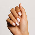 Hand with soft pink manicure showcasing smooth nails, ideal for nourishing with Cuticle Serum Duo for healthy cuticles thumbnail