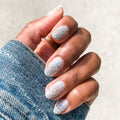Hand with nails covered in Olive and June Exclamation Point silver holographic glitter polish for a sparkling manicure thumbnail