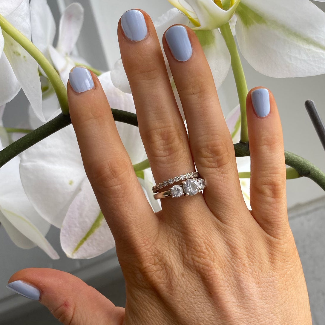 Hand with nails painted in BP, a pastel icy light blue gel polish for a smooth and long-lasting manicure at home