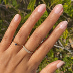 Hand with natural-shaped nails painted in shimmery Pink Capiz long-lasting polish for a soft manicure look