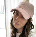 O&J Nails Hat in soft pink cotton twill featuring subtle Nails Nails Nails embroidery and adjustable strap worn by woman thumbnail