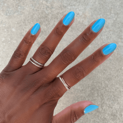 Megababe Blue polish on customer hand